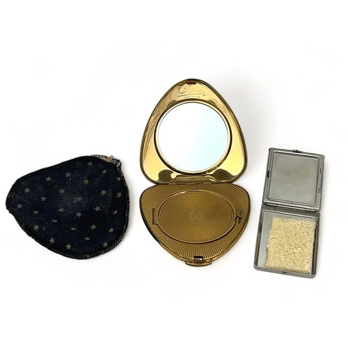 55 - Two compacts. A heart shaped gold-toned Kigu compact with white metal and marcasite decoration and w... 