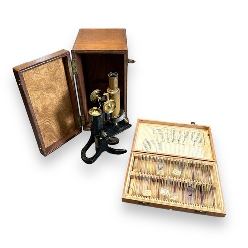 165 - J Swift & Son Microscope with fitted wooden case. Comes with a case of over 100 prepared slides cove... 