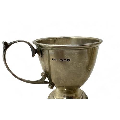 70 - Five hallmarked silver items including two Christening mugs, a cup, a jug and a trophy.Total weight ... 