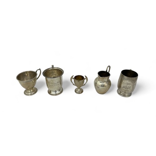 70 - Five hallmarked silver items including two Christening mugs, a cup, a jug and a trophy.Total weight ... 