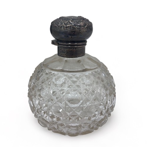 103 - A silver mounted glass bottle, approx 11cm in height. Hallmarks for Levi & Salaman, Birmingham 1910.