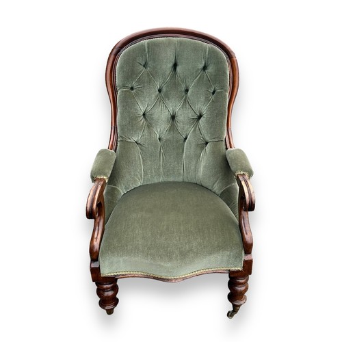 481 - Victorian mahogany upholstered spoonback armchair with green fabric, wheeled feet. Height 100cm, wid... 