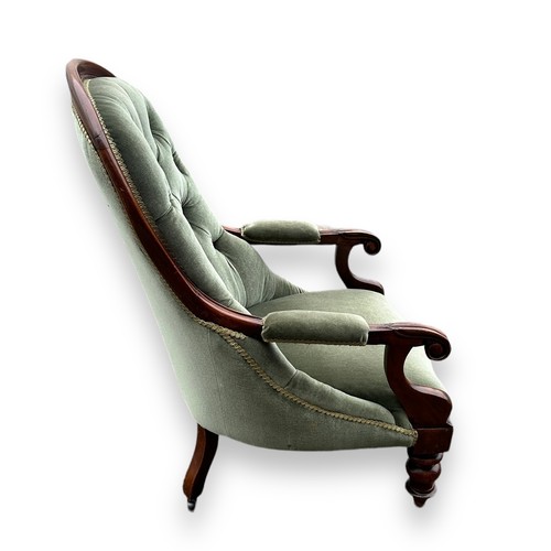 481 - Victorian mahogany upholstered spoonback armchair with green fabric, wheeled feet. Height 100cm, wid... 