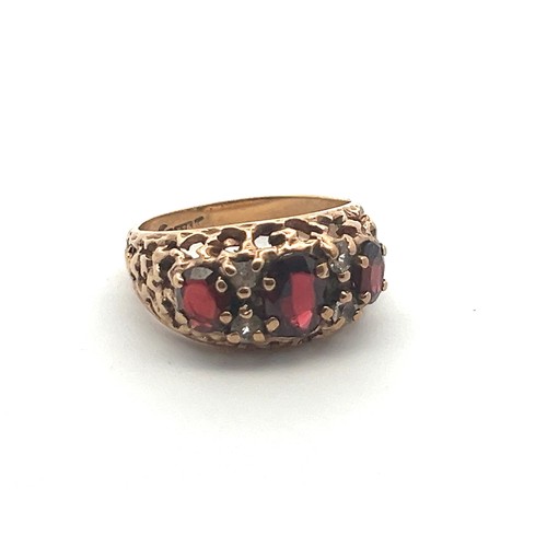 53 - A 9ct gold and garnet ring with white stone accents, size M. Birmingham hallmarks, Sponsor D&W.