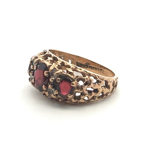 53 - A 9ct gold and garnet ring with white stone accents, size M. Birmingham hallmarks, Sponsor D&W.