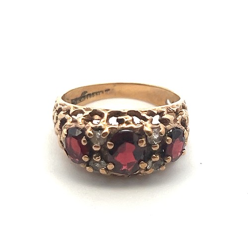 53 - A 9ct gold and garnet ring with white stone accents, size M. Birmingham hallmarks, Sponsor D&W.