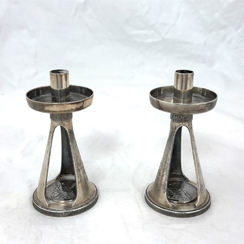 98 - A pair of Christopher Nigel Lawrence candlesticks each with a plain circular sconce on a textured ta... 