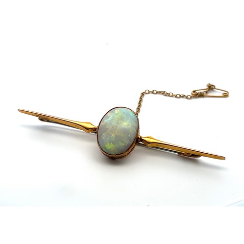 19 - An opal bar brooch stamped 9ct. Opal approx 18 x 13mm. Weight 4.53g. Length 7.5cm. Opal with lots of... 