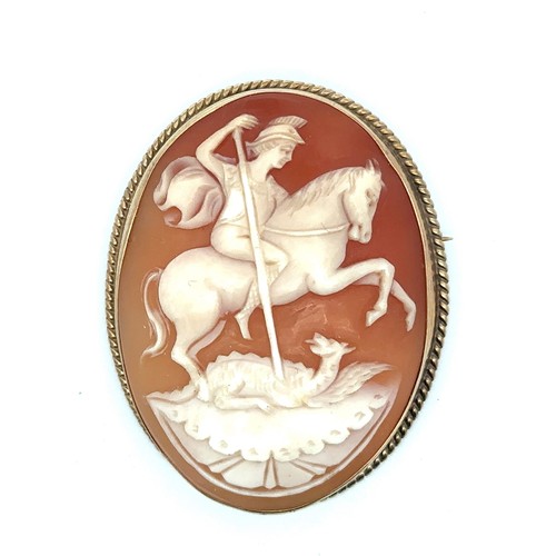 20 - A hallmarked 9ct gold shell cameo brooch with rope twist surround depicting St George killing a drag... 