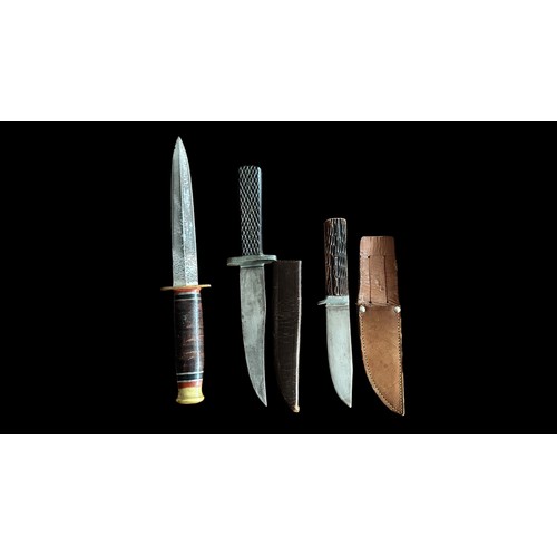 91 - A trio of daggers including a Taylor Witness Second World War Fighting Knife, a Bukta dagger with wo... 