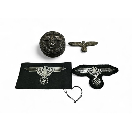 125 - German Third Reich snuff box with repeated eagle design. Plus, Eagle badge and two eagle patches.