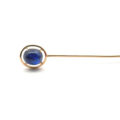 10 - A sapphire cabochon pin set in unmarked gold, mount tested using XRF as 15ct gold. Sapphire 8mm x mm... 