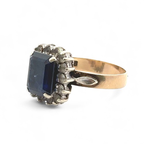 77 - A synthetic sapphire and white stone cluster ring stamped 9ct, size O.  Sapphire 9mm x 7mm. Missing ... 