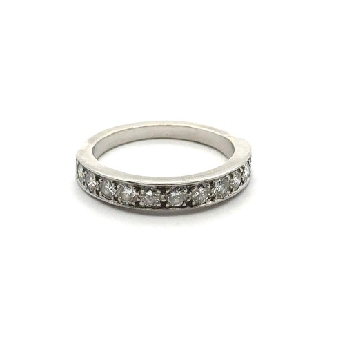 66 - An eleven stone diamond half eternity ring, size  M. Unmarked white metal tested as platinum using X... 