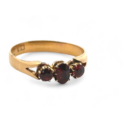 38 - A three stone garnet ring, size O. Hallmarks rubbed and unclear but tested as using XRF as 18ct gold... 