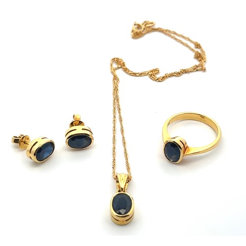 39 - A sapphire and 18ct gold necklace, earrings and ring set. Pendant set with sapphire 8mm x 6mm, stamp... 