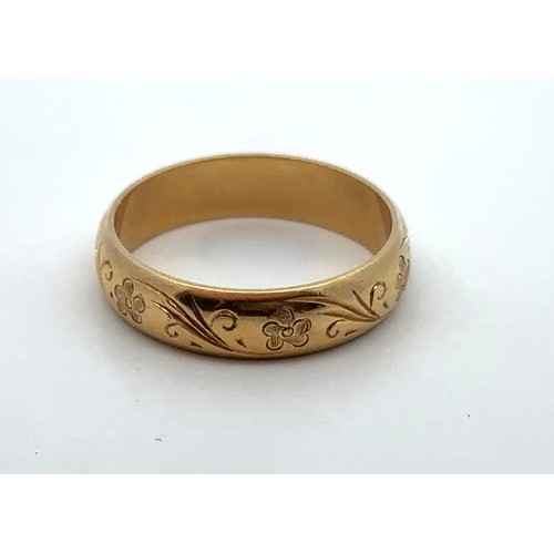 1 - An 18ct yellow gold ring with engraved foliate decoration, size O Size Hallmarks for CG & S, Birming... 