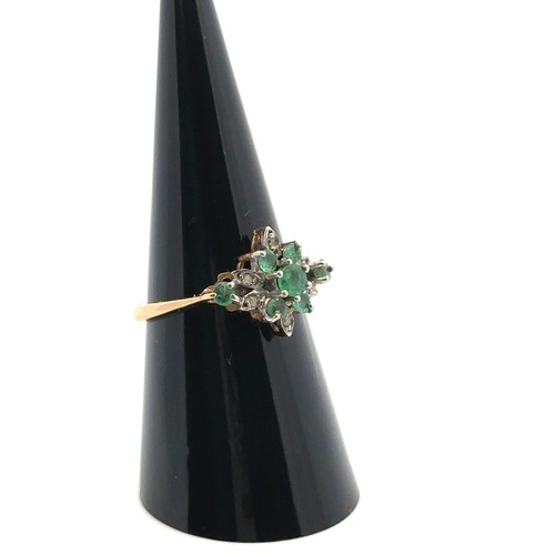 26 - An emerald and diamond cluster ring, size O,  stamped 14ct. Weight 2.53g.