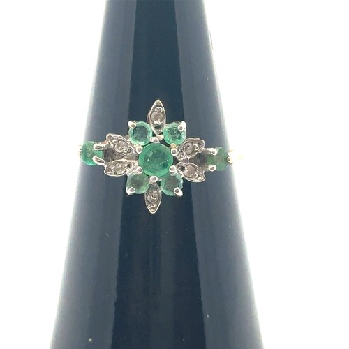 26 - An emerald and diamond cluster ring, size O,  stamped 14ct. Weight 2.53g.