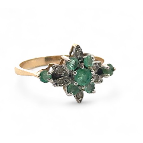 26 - An emerald and diamond cluster ring, size O,  stamped 14ct. Weight 2.53g.