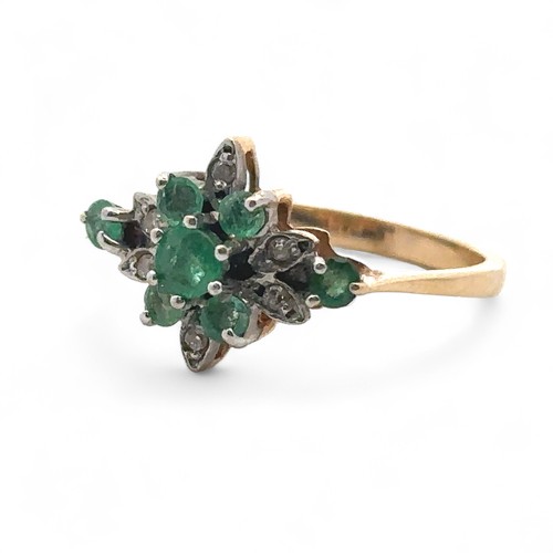 26 - An emerald and diamond cluster ring, size O,  stamped 14ct. Weight 2.53g.