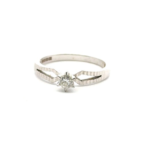 35 - An 18ct white gold single stone ring, size M. Estimated diamond weight 0.15ct. Weight 3.1g