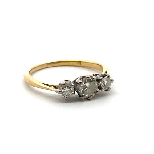 15 - A three stone diamond ring, size L in unmarked yellow metal, tested as 18ct using XRF. Central diamo... 