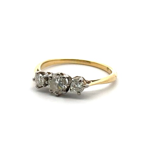 15 - A three stone diamond ring, size L in unmarked yellow metal, tested as 18ct using XRF. Central diamo... 