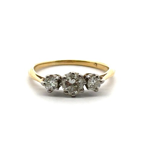 15 - A three stone diamond ring, size L in unmarked yellow metal, tested as 18ct using XRF. Central diamo... 