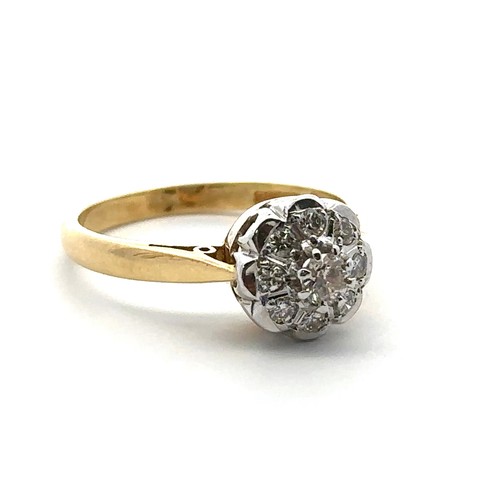 64 - A modern 18ct yellow and white gold flower ring set with nine diamonds. Size O. Principal diamond 0.... 