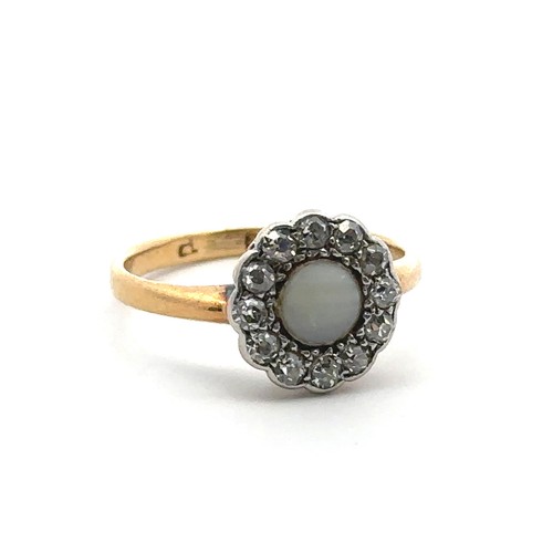 75 - A foil backed white chalcedony and diamond cluster ring stamped 18ct, size J. Inscription to inner s... 