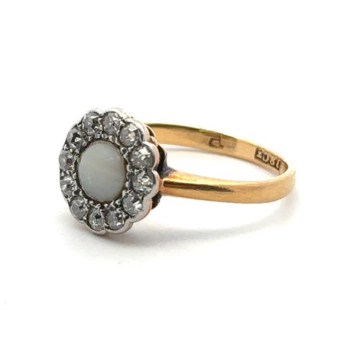 75 - A foil backed white chalcedony and diamond cluster ring stamped 18ct, size J. Inscription to inner s... 