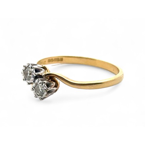 49 - 18ct gold and diamond crossover ring set with two diamonds, each around 0.07ct. Size S.  Hallmarks f... 