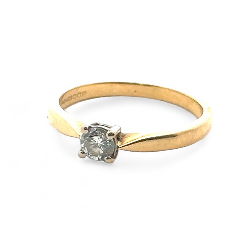 60 - A 0.2ct diamond solitaire ring set in hallmarked 18ct yellow gold, size J. Sponsor E.F. Weight 2.2g.