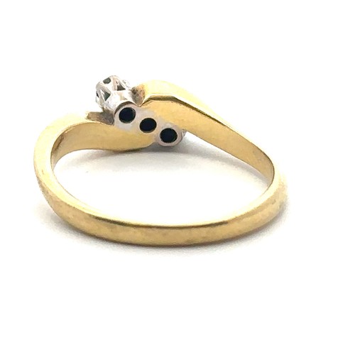 69 - An 18ct yellow gold three stone diamond crossover ring, size N. Estimated total diamond weight 0.25c... 