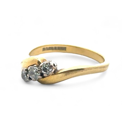 69 - An 18ct yellow gold three stone diamond crossover ring, size N. Estimated total diamond weight 0.25c... 