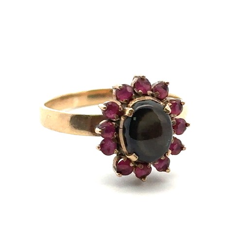 28 - A gold sheen obsidian and ruby cluster ring, size P. Weight 3.13g. Obsidian approx 8mm x 6mm. Stampe... 