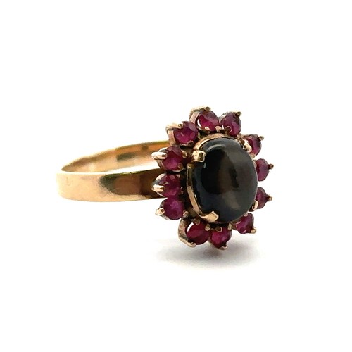 28 - A gold sheen obsidian and ruby cluster ring, size P. Weight 3.13g. Obsidian approx 8mm x 6mm. Stampe... 