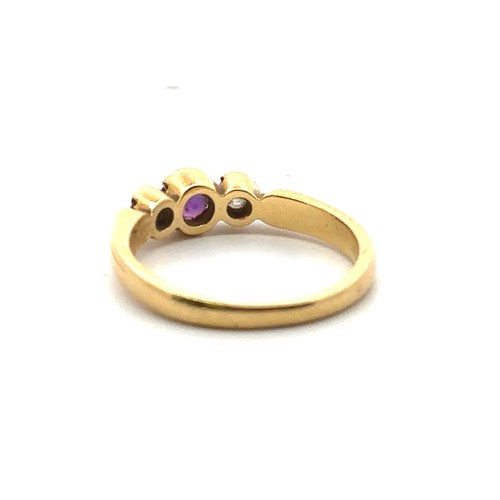 29 - An 18ct gold, amethyst and diamond three stone ring, size M.  Total diamond weight approx 0.14ct. We... 