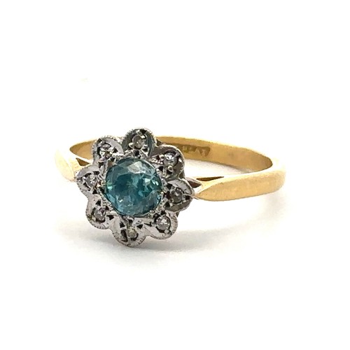 70 - A blue zircon and diamond flower ring stamped 18ct and Plat. Size O/P.  Condition. Overall good. Sma... 