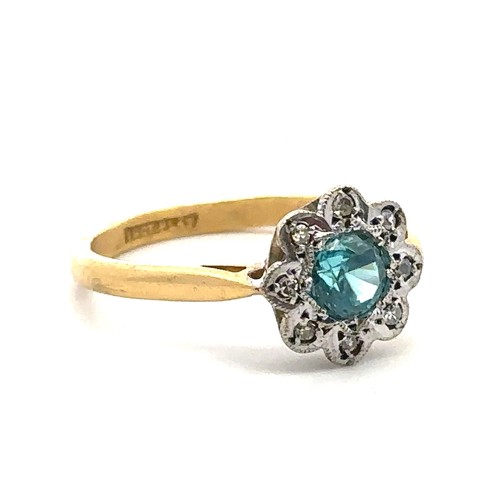 70 - A blue zircon and diamond flower ring stamped 18ct and Plat. Size O/P.  Condition. Overall good. Sma... 