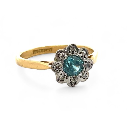 70 - A blue zircon and diamond flower ring stamped 18ct and Plat. Size O/P.  Condition. Overall good. Sma... 