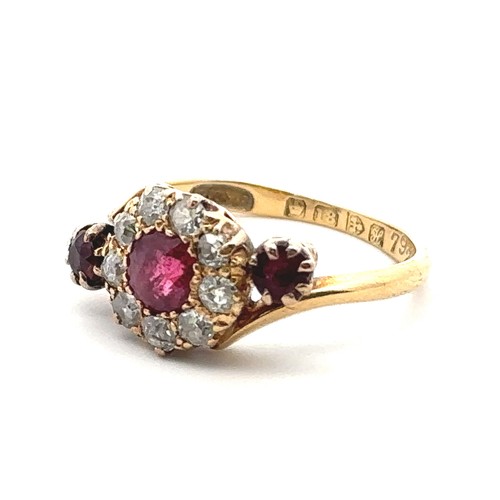 20 - An unusual ruby and old cut diamond cluster ring in a crossover setting and flanked by a ruby on eac... 