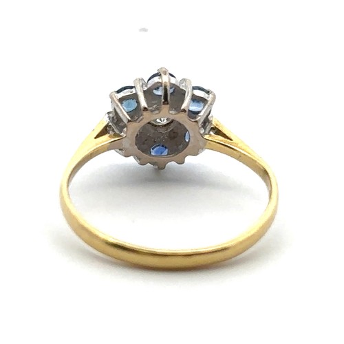 21 - A modern 18ct sapphire and diamond flower ring, size L. Central diamond approx 0.17ct. Hallmarks for... 