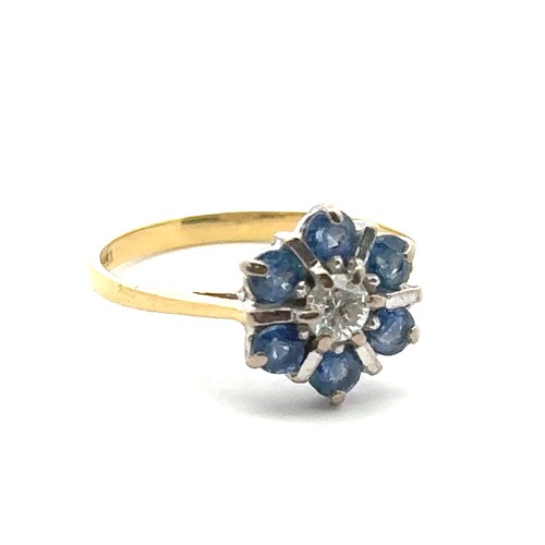 21 - A modern 18ct sapphire and diamond flower ring, size L. Central diamond approx 0.17ct. Hallmarks for... 