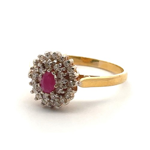 22 - A 22ct gold, ruby and diamond cluster ring. Central oval ruby approx 45mmx 3mm surrounded by a doubl... 