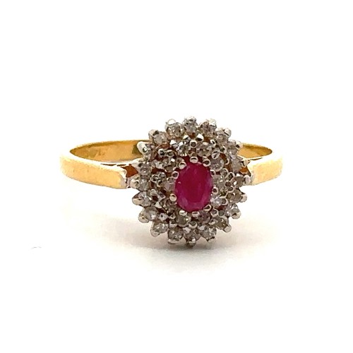 22 - A 22ct gold, ruby and diamond cluster ring. Central oval ruby approx 45mmx 3mm surrounded by a doubl... 