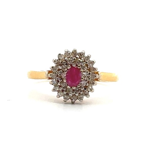 22 - A 22ct gold, ruby and diamond cluster ring. Central oval ruby approx 45mmx 3mm surrounded by a doubl... 