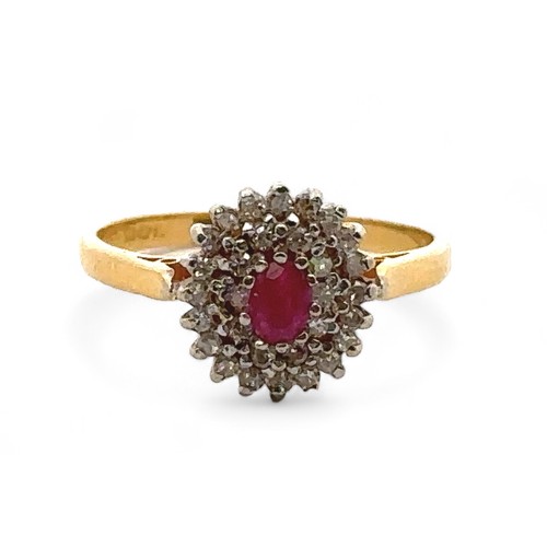 22 - A 22ct gold, ruby and diamond cluster ring. Central oval ruby approx 45mmx 3mm surrounded by a doubl... 