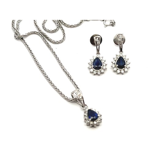 30 - A sapphire and diamond necklace and earrings set. The necklace with a central pear shaped sapphire s... 